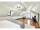 Bedroom with office area, hard wood floors, white paint, and angled ceilings from attic space at 1725 W 53Rd St, Indianapolis, IN 46228