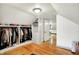 Spacious walk-in closet with custom shelving, hanging rods and lots of storage space in an attic remodel at 1725 W 53Rd St, Indianapolis, IN 46228