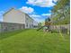 Large backyard features a playset, a well-manicured lawn and privacy fence at 1843 Winchester Blvd, Avon, IN 46123
