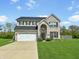 Charming two-story home with a well-manicured lawn and a two-car garage at 1843 Winchester Blvd, Avon, IN 46123