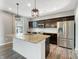 Stylish kitchen with dark cabinets, granite countertops, and a stainless steel refrigerator at 1843 Winchester Blvd, Avon, IN 46123