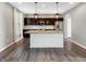 Modern kitchen with a large island, granite countertops, and stainless steel appliances at 1843 Winchester Blvd, Avon, IN 46123