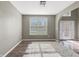 Open-concept living room with hardwood floors, large window, and white trim at 1843 Winchester Blvd, Avon, IN 46123