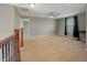Open loft area featuring neutral paint, ceiling fan and an open railing overlooking the stairs at 1843 Winchester Blvd, Avon, IN 46123