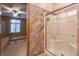 An attached bathroom offering a glass-enclosed shower, tiled walls and adjacent bedroom creating a private retreat at 1858 Broadleaf Ct, Greenwood, IN 46143