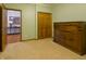 The bedroom has neutral walls, an adjacent room visible through the door and a custom built-in cabinet at 1858 Broadleaf Ct, Greenwood, IN 46143