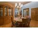 A dining room is set for a cozy meal, boasting a chandelier and vintage wooden china cabinet at 1858 Broadleaf Ct, Greenwood, IN 46143