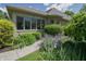 Beautiful home exterior featuring lush gardens, a stone walkway, and manicured landscaping under a bright, sunny sky at 1858 Broadleaf Ct, Greenwood, IN 46143