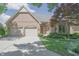 Charming brick home featuring a well-manicured lawn and a convenient two-car garage at 1858 Broadleaf Ct, Greenwood, IN 46143