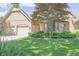 Charming brick home featuring a well-manicured lawn and a convenient two-car garage at 1858 Broadleaf Ct, Greenwood, IN 46143