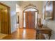 Inviting foyer with hardwood floors and a decorative arched doorway at 1858 Broadleaf Ct, Greenwood, IN 46143