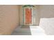 Close-up view of a stylish front door with orange paint at 1858 Broadleaf Ct, Greenwood, IN 46143