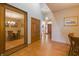 Hallway featuring wood floors, decorative light fixture, and view into the formal dining room at 1858 Broadleaf Ct, Greenwood, IN 46143