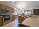 Well-lit kitchen with granite countertops, stainless steel appliances, tile backsplash, and a dining area at 1858 Broadleaf Ct, Greenwood, IN 46143