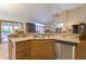 Open kitchen features a stainless steel dishwasher and mosaic backsplash at 1858 Broadleaf Ct, Greenwood, IN 46143