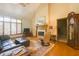 Open living room with a fireplace, comfortable seating, windows, and wooden accents throughout at 1858 Broadleaf Ct, Greenwood, IN 46143