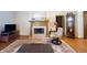 Comfortable living room featuring a fireplace, wooden accents, a swivel chair, and plush carpeting at 1858 Broadleaf Ct, Greenwood, IN 46143