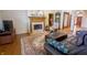 Cozy living room with a fireplace, leather seating, decorative rug, and view to the entryway at 1858 Broadleaf Ct, Greenwood, IN 46143