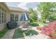 Cozy backyard patio with outdoor furniture, including a grill, surrounded by lush greenery, ideal for outdoor entertaining at 1858 Broadleaf Ct, Greenwood, IN 46143