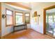 Sitting area with natural light, hardwood floors, a view of the backyard, and access to the sunroom at 1858 Broadleaf Ct, Greenwood, IN 46143