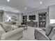 Finished basement with comfortable seating around a coffee table and large media center at 187 N Bend Dr, Greenwood, IN 46142