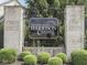 The Estates at Harrison Crossing entrance sign with manicured bushes and brick pillars at 187 N Bend Dr, Greenwood, IN 46142