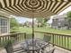 Outdoor seating area with an umbrella on a wooden deck overlooking a green lawn at 187 N Bend Dr, Greenwood, IN 46142