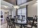 Elegant dining room featuring a coffered wood ceiling, stylish lighting, and a large window at 187 N Bend Dr, Greenwood, IN 46142