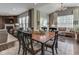 Open-concept dining area with hardwood floors, a large dining table, and views into the living room at 187 N Bend Dr, Greenwood, IN 46142
