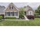 Charming brick home with manicured lawn, beautiful landscaping, and elegant architectural details at 187 N Bend Dr, Greenwood, IN 46142