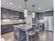 Gourmet kitchen featuring a large island, granite countertops, stainless steel appliances, and modern pendant lighting at 187 N Bend Dr, Greenwood, IN 46142