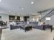 Open-concept living room with large sectional sofa and view of the kitchen and staircase at 187 N Bend Dr, Greenwood, IN 46142