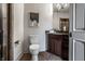 Elegant bathroom with a dark wood vanity, granite countertop, and decorative wall art at 1894 Rhettsbury St, Carmel, IN 46032
