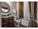 Charming bathroom with a tiled shower, white fixtures, and a decorative vanity at 1894 Rhettsbury St, Carmel, IN 46032