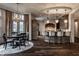 Dining area open to the kitchen, highlighted by a stylish chandelier and lots of natural light at 1894 Rhettsbury St, Carmel, IN 46032