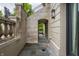 Stone-paved walkway under an archway, with a glimpse of green landscaping, adds a touch of elegance to the property at 1894 Rhettsbury St, Carmel, IN 46032