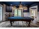 Well-lit game room featuring a pool table, custom lighting, and seating area at 1894 Rhettsbury St, Carmel, IN 46032