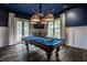 Well-lit game room featuring a pool table, custom lighting, and outdoor access at 1894 Rhettsbury St, Carmel, IN 46032
