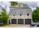 Three-car garage with an attached living space boasts a slate tile roof and elegant black window frames at 1894 Rhettsbury St, Carmel, IN 46032
