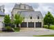 A three-car garage with stylish arched windows and well-maintained landscaping enhances the property's value at 1894 Rhettsbury St, Carmel, IN 46032