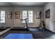 Bright home gym with mirrored wall, treadmill, and exercise equipment at 1894 Rhettsbury St, Carmel, IN 46032