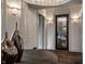 Hallway showcases artful lighting and flows into a wine cellar with a glass door, complemented by decorative vases at 1894 Rhettsbury St, Carmel, IN 46032