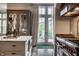 Bright kitchen with stainless steel range, white marble countertops, and cabinet with glass door at 1894 Rhettsbury St, Carmel, IN 46032