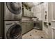 Well-organized laundry room with modern appliances, custom cabinets, and dog bed at 1894 Rhettsbury St, Carmel, IN 46032