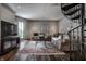 Comfortable living room with decorative sofas, a patterned rug, and a spiral staircase at 1894 Rhettsbury St, Carmel, IN 46032
