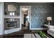 Chic living room with a fireplace, decorative wallpaper, and elegant furnishings at 1894 Rhettsbury St, Carmel, IN 46032