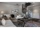 Cozy living room showcases a spiral staircase, comfortable seating, and stylish decor, creating an inviting atmosphere at 1894 Rhettsbury St, Carmel, IN 46032