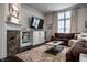 Living room with a fireplace, built-in cabinets, and a comfortable brown sectional sofa at 1894 Rhettsbury St, Carmel, IN 46032