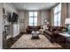 Inviting living room featuring a comfortable brown sectional sofa and lots of natural light at 1894 Rhettsbury St, Carmel, IN 46032