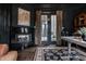 Sophisticated office featuring custom fireplace, artwork, and backyard access at 1894 Rhettsbury St, Carmel, IN 46032